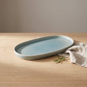 Turquoise ovaal bord 30 cm van L'AMAR, sfeerfoto 1 op een gedekte tafel